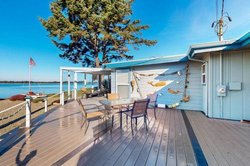 Coos Bay House | Waterfront home with panoramic bay views deck fireplace & beach access