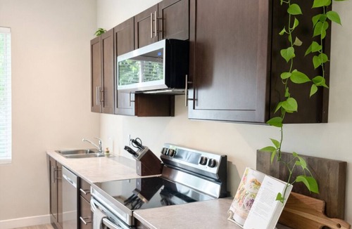 Otter Point Apartment | Private creekside retreat with sauna, fire pit & rain shower.