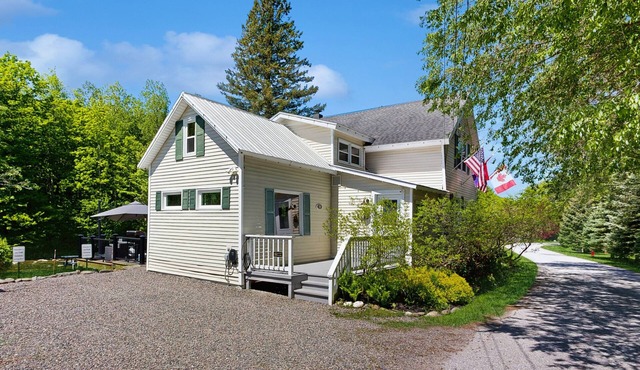 Inviting riverfront home with hot tub on deck & fireplace, near skiing & golf